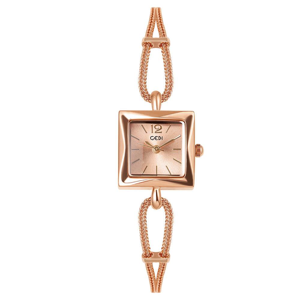 Rose gold watch with a square face on a white background