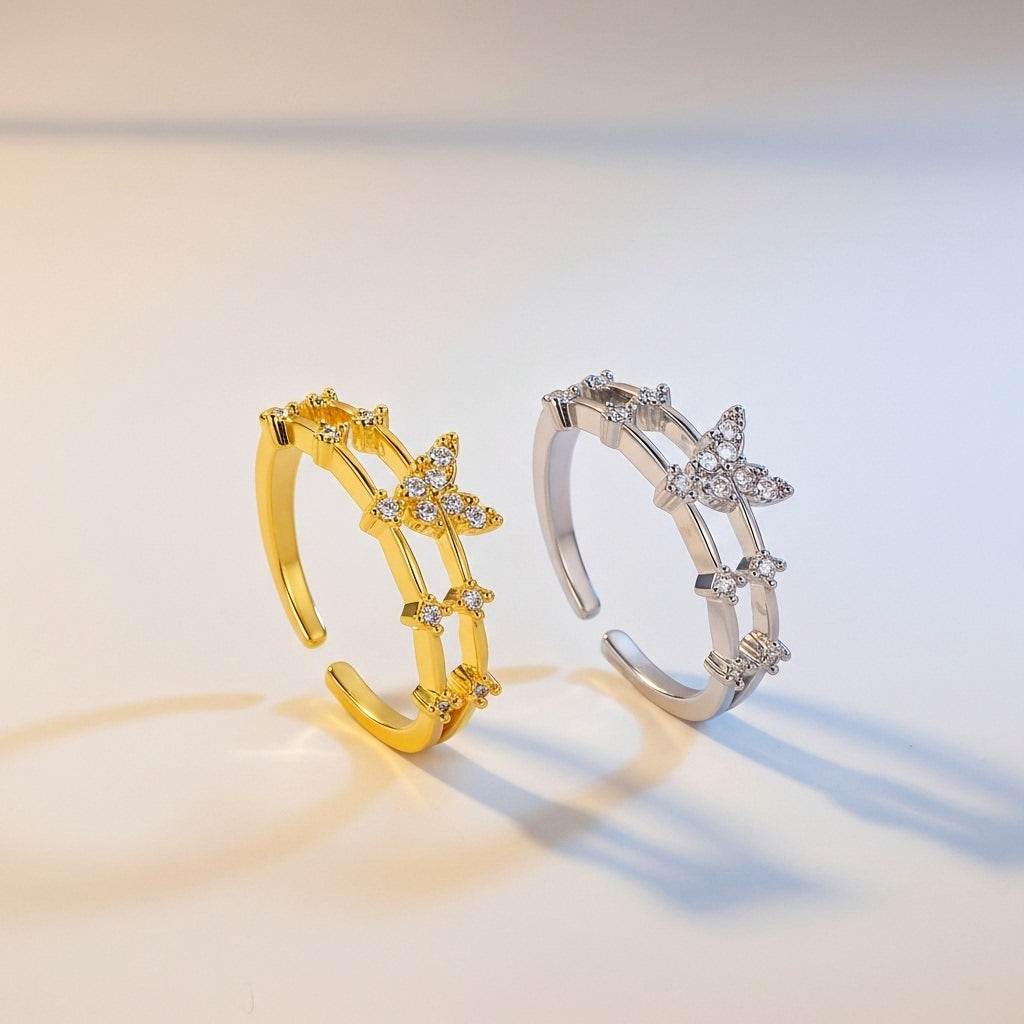 Gold and silver open rings with star designs on a gradient background