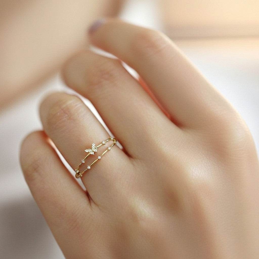 Gold ring with star design on a hand against a blurred background