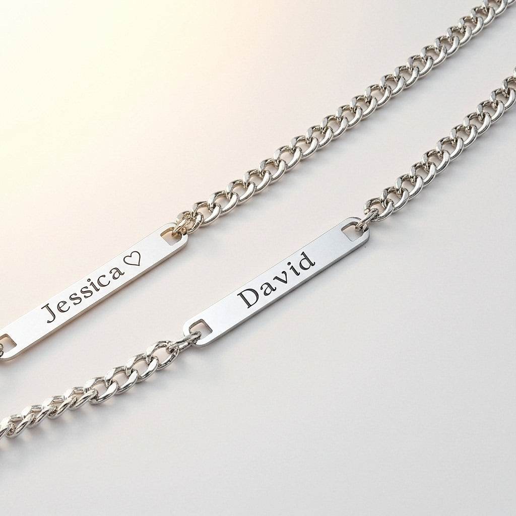Two silver bracelets with engraved names on a light background