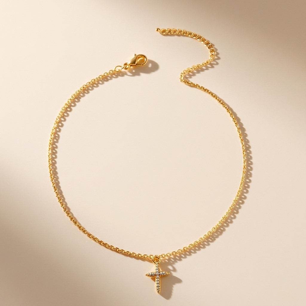 Gold necklace with a small pendant on a beige background