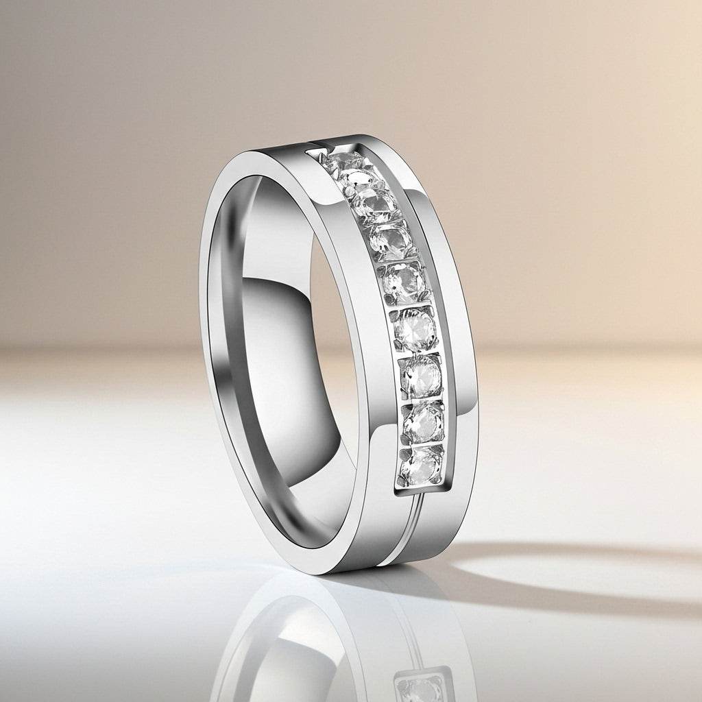 Silver ring with embedded diamonds on a reflective surface